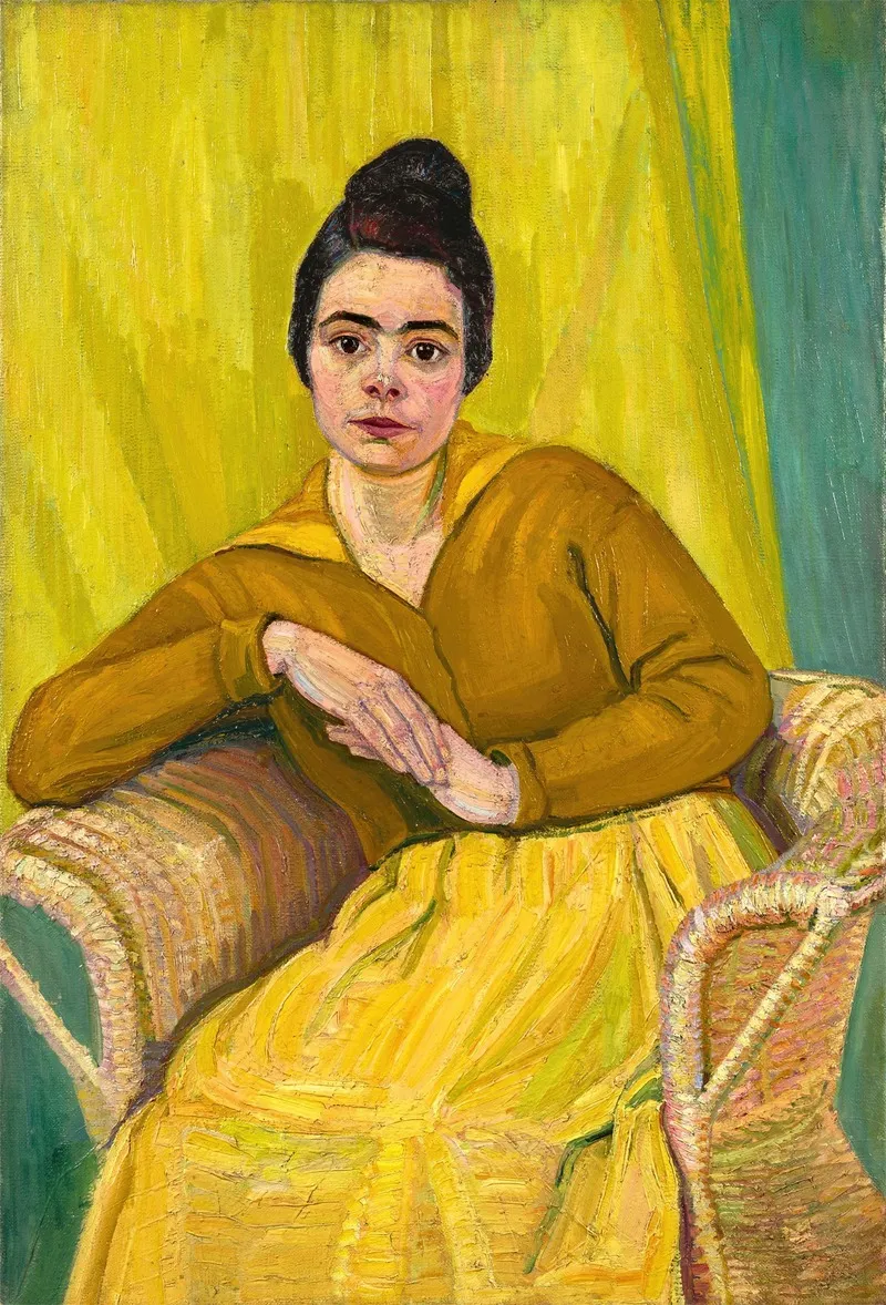 Dame assise dans une chaise en osier (environ 1910)